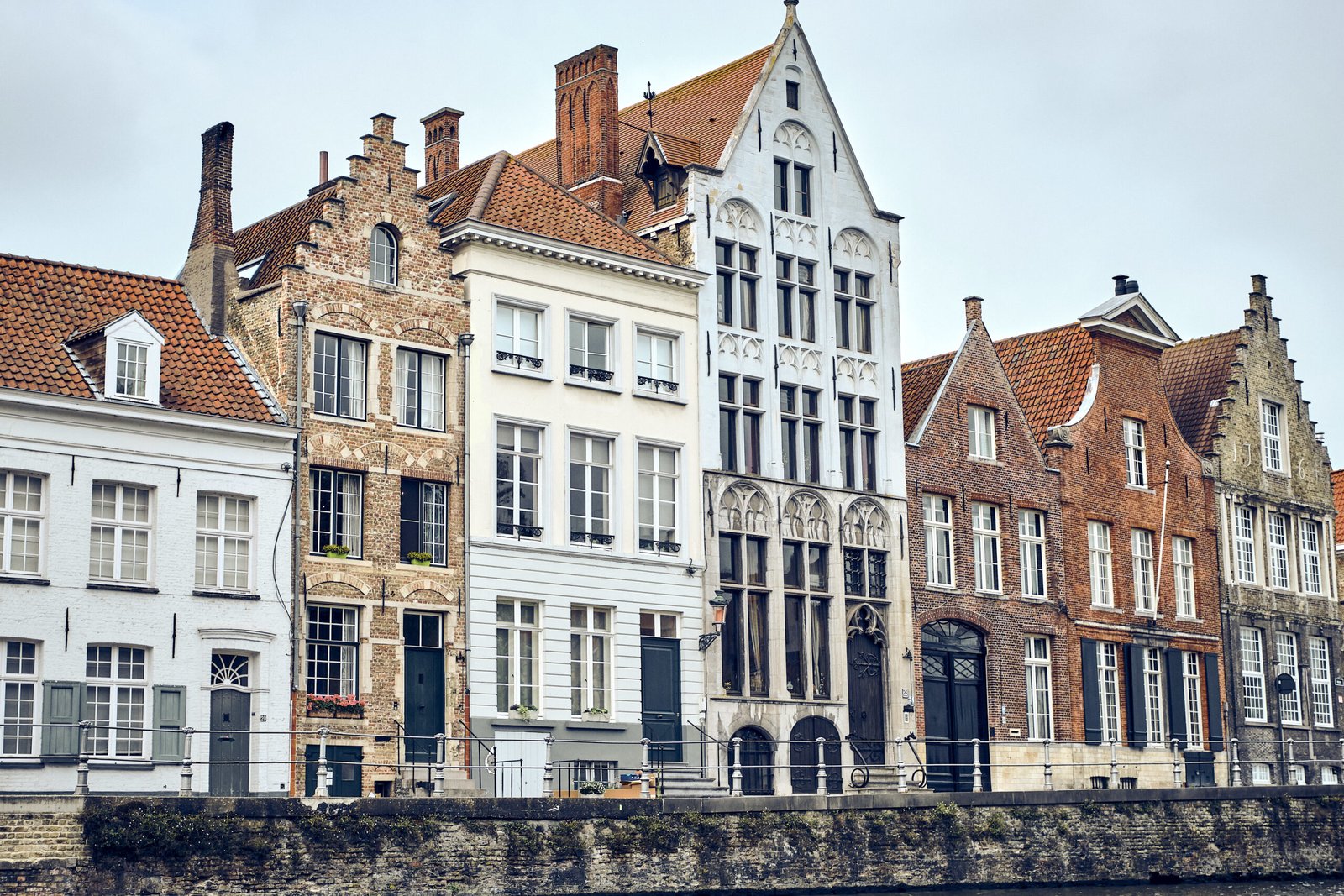 A view of an old town of Bruges in Belgium on a white sky background